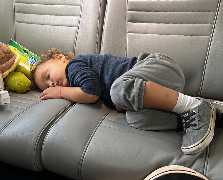 boy sleeping on train