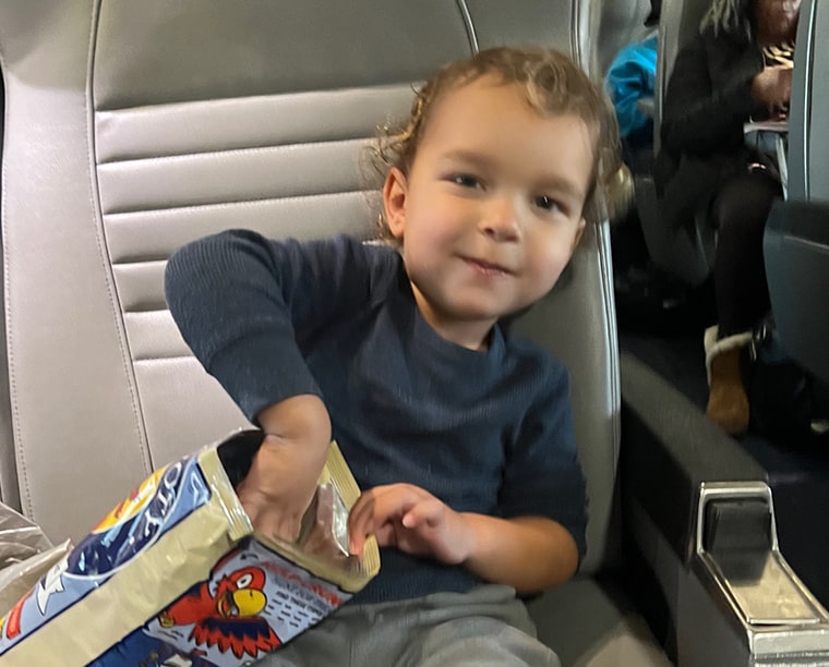 little boy eating on train