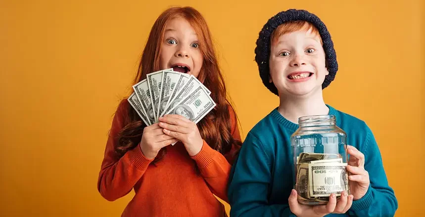 excited boy and girl holding dollar bills