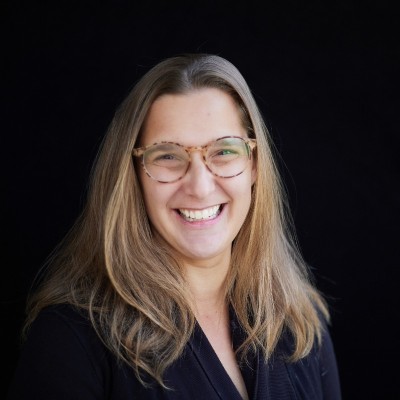 Headshot of Sara Owens, a family travel advisor woman with long blonde hair and glasses.